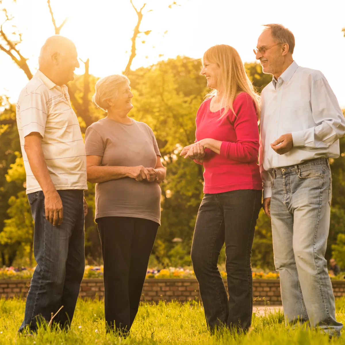 Mature friends talking together in warm evening light